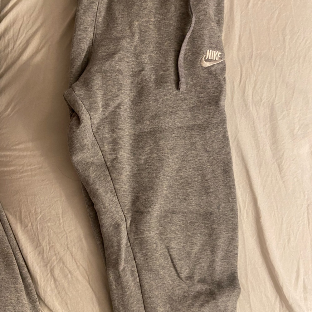 Gray Nike sweatpants with a pocket on the back.